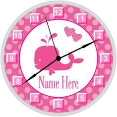 a pink and white clock with a whale on it's face that says name here