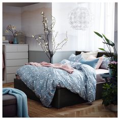 a bed with blue and pink comforters in a bedroom