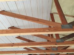 the inside of a building with wooden beams