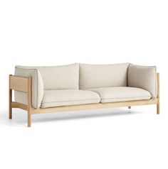 a white couch sitting on top of a wooden frame