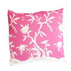 a pink pillow with white flowers on it