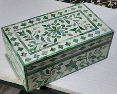 a green and white box sitting on top of a table