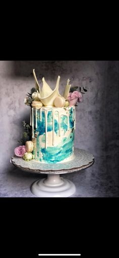 a blue and white cake sitting on top of a table