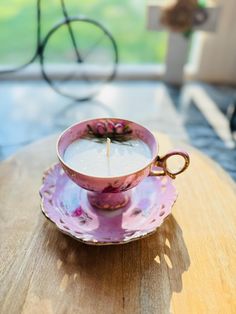 a tea cup sitting on top of a saucer with a candle in the middle