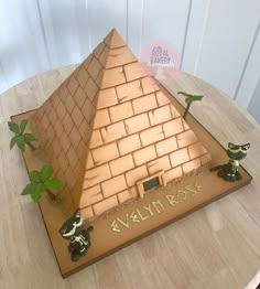 a cake that is shaped like a pyramid with plants growing out of the top and bottom