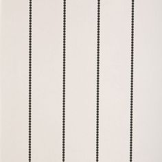 a black and white striped wallpaper with small dots on the bottom half of it