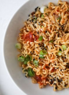 a white bowl filled with noodles and vegetables