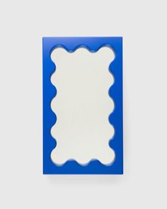 a blue and white frame with scalloped edges on a gray background, in the shape of a rectangle