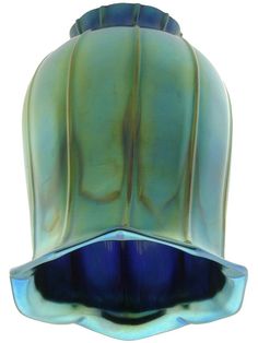 a blue glass vase sitting on top of a white table