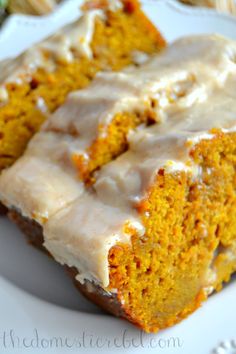 a close up of a piece of cake on a plate with frosted icing