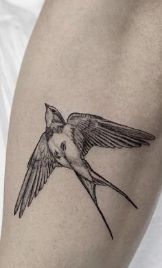 a small bird tattoo on the right thigh