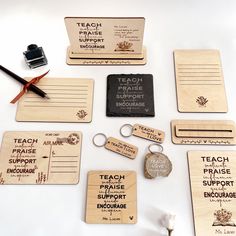 several wooden business cards and keychains are laid out on a white surface with scissors