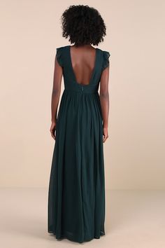 the back of a woman in a long green dress