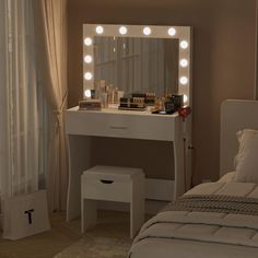 a white vanity with lights on it and a bed in front of the mirror,