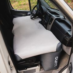 the interior of a vehicle with its seat up and storage bag in the passenger side door