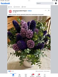 a vase filled with purple flowers on top of a table