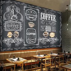 a chalkboard wall in a restaurant with tables and chairs