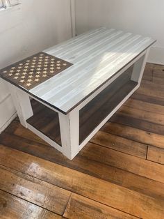 a white coffee table sitting on top of a hard wood floor