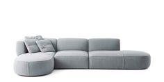 a large gray couch with pillows on it's back and side ends, sitting in front of a white background