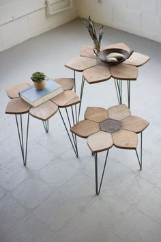 three wooden tables with metal legs and flowers on them