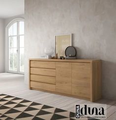 an empty room with a large wooden dresser in the center and a checkered rug on the floor