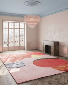 a living room with pink walls and a rug on the floor in front of a fireplace