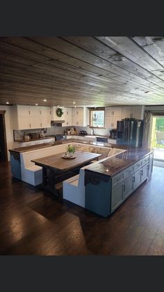 an open kitchen and dining room with wood flooring is pictured in this image from the inside