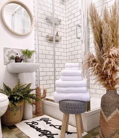 towels are stacked on stools in the bathroom