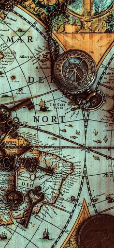 an old world map with keys and other items on the top, including a pocket watch