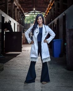 a woman is standing in the middle of an alley way with her hands on her hips