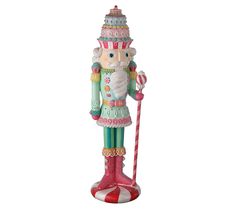 a statue of a nutcracker holding a candy cane