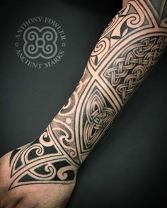 a man's arm with an intricate tattoo design on the forearm and hand,