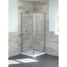 a corner shower stall in a bathroom with grey tile walls and floor tiles on the wall