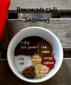 the ingredients for homemade chili seasoning in a white bowl on top of a wooden table