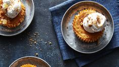 three small desserts on plates with whipped cream