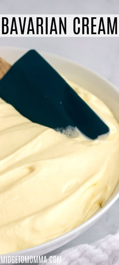 a white bowl filled with yellow batter and a spatula on top of the cake