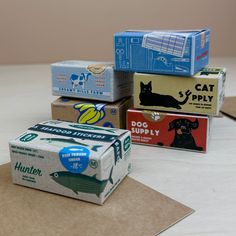 several boxes of cat litter sitting on top of a table next to brown envelopes