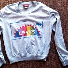 Seldom Found True Vintage 70's Long Sleeve Sweatshirt-Style (But Its Not Heavy Like Sweatshirt So Its Like A Ribbed Long Sleeve T-Shirt) Levis Baby Blue Color T-Shirt. In Very Nice Vintage, Wearable Condition, Light Signs Of Use But Nothing That Jumps Out At You At All. Hard To Find Vintage Logo Tee With The Original Levis Tag That You Normally Find On Jackets Etc. Sleeve From Shoulders 22", Chest 18.5", Length From Center Back Neckline Seam 21.75", Shoulders 19". Baby Blue Color, Sweatshirt Style, Baby Blue Colour, Logo Tee, Vintage Logo, Logo Tees, True Vintage, Long Sleeve Sweatshirts