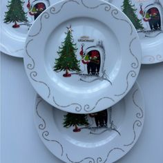 three plates decorated with christmas scenes and trees