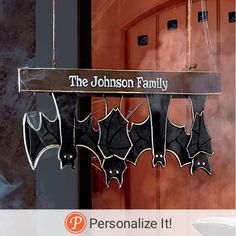 a group of bats hanging from a sign that says, the johnson family personalize it