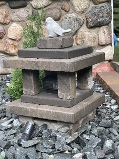 a bird is sitting on top of a stone lantern