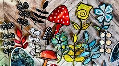 an artistic painting of flowers and mushrooms on wood