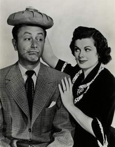 an old black and white photo of a man with a hat on top of his head