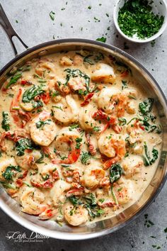 a pan filled with food sitting on top of a table next to a bowl and spoon