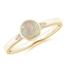 Bezel-set in 14k yellow gold is the round opal, displaying a scintillating play of color. It is flanked by glittering pave-set diamond accents, nestled within the cutout grooves. This solitaire opal ring is simple but stunning. Solitaire Opal Ring, Opal Solitaire Ring, Popular Rings, Ring With Diamond, Bezel Diamond, Opal Ring, Ring Size Guide, Opal Rings, Bezel Setting