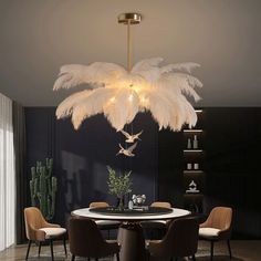 a chandelier hanging over a dining room table with chairs and a potted plant