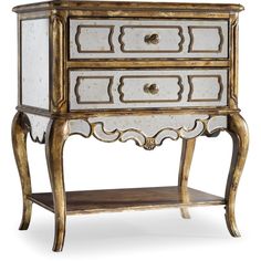 an ornate gold and white cabinet with drawers on it's legs, against a white background