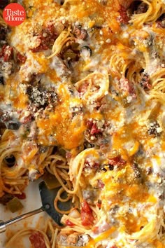 a casserole dish with meat, cheese and tomato sauce on the side is shown