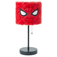 a red lamp with a spiderman face on it