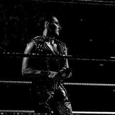 a woman standing in the middle of a wrestling ring